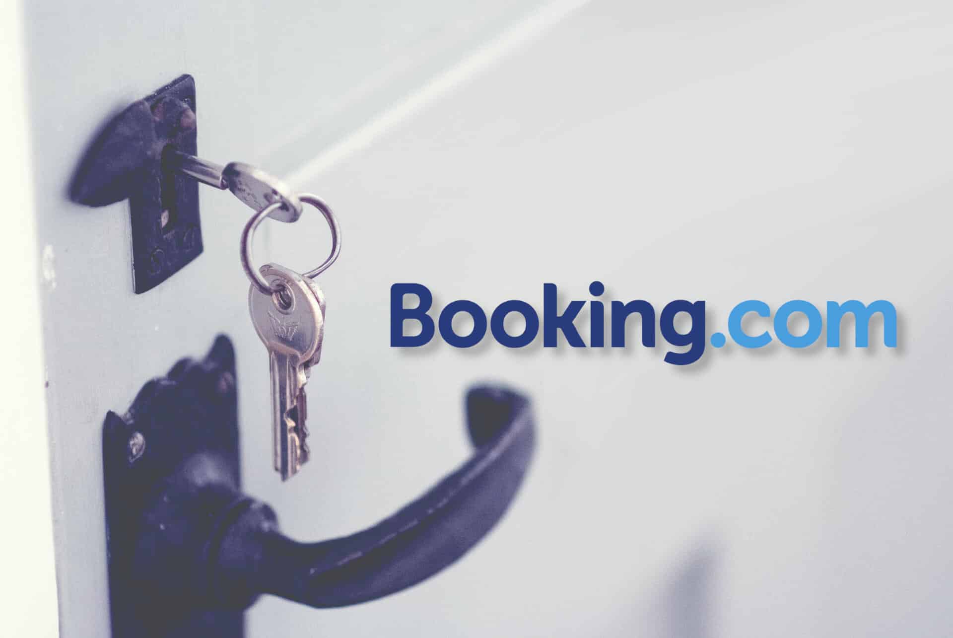 Sleutel op een witte deur met Booking.com Logo.
